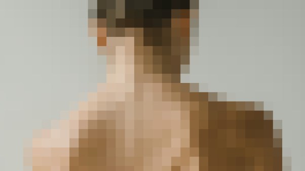 A pixelated image of a woman's neck and shoulders.