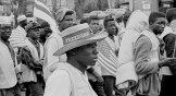 A man with a straw hat walks with others on the Selma to Montgomery marches held in support of voter rights in late March of 1965.