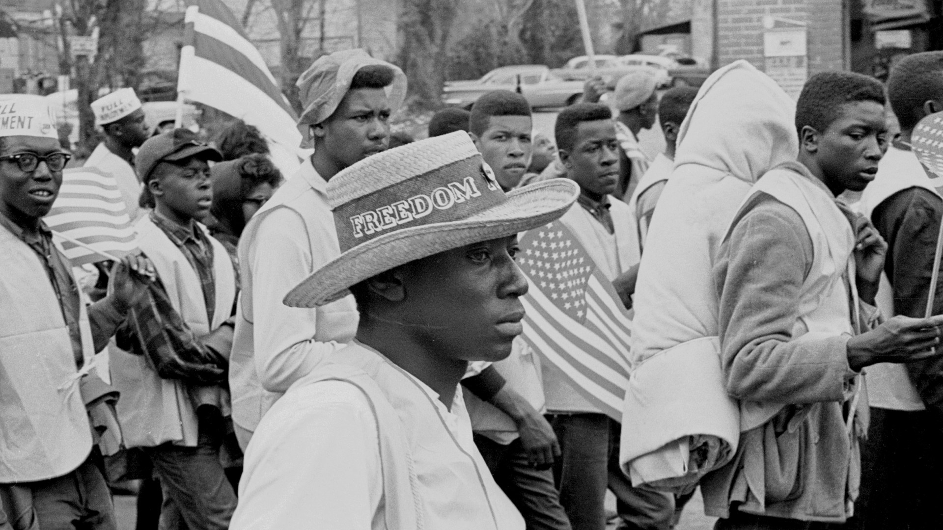 A man with a straw hat walks with others on the Selma to Montgomery marches held in support of voter rights in late March of 1965.