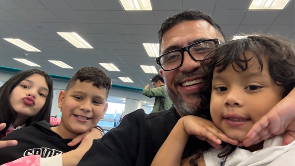 Pastor Elias Rodriguez with three children he flew to Venezuela to reunite with their mother after she was deported without them.