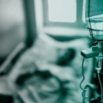 An IV and hospital bed.