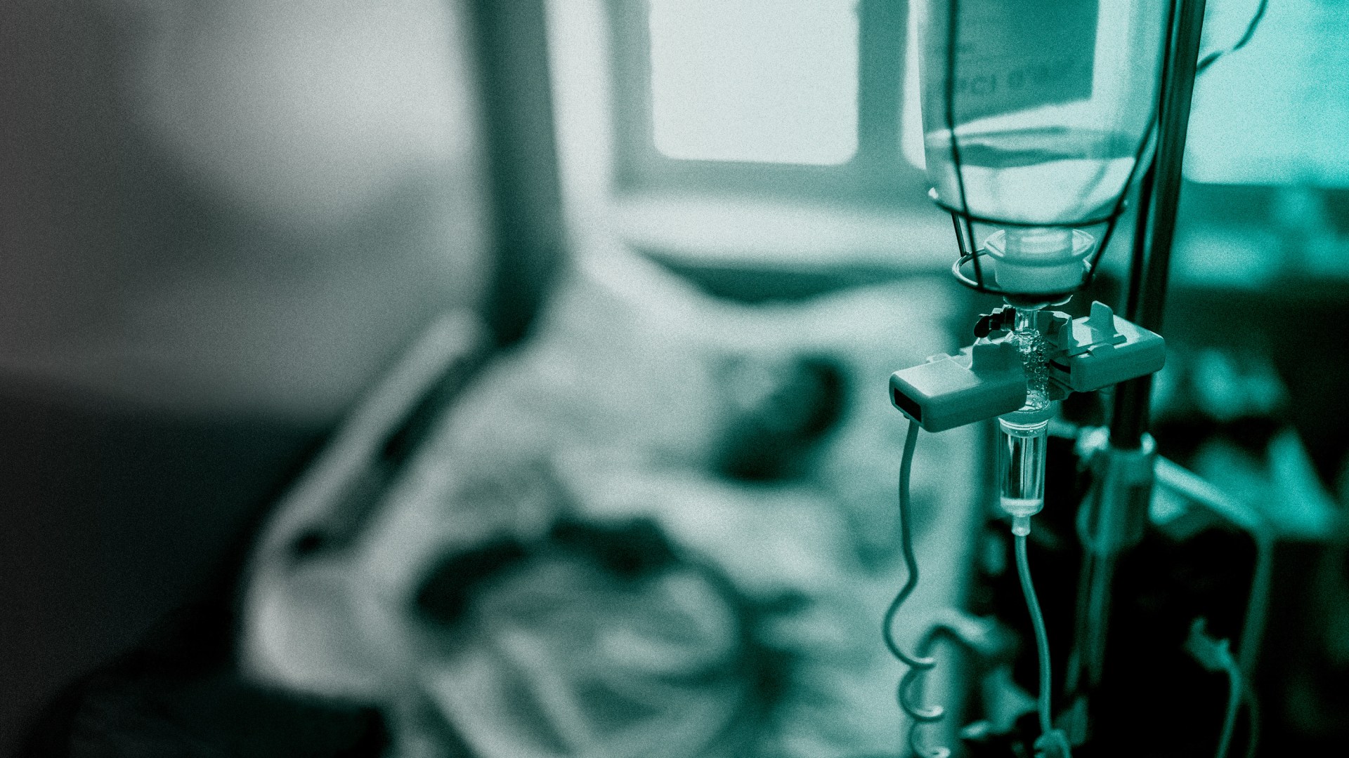 An IV and hospital bed.