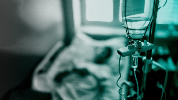 An IV and hospital bed.