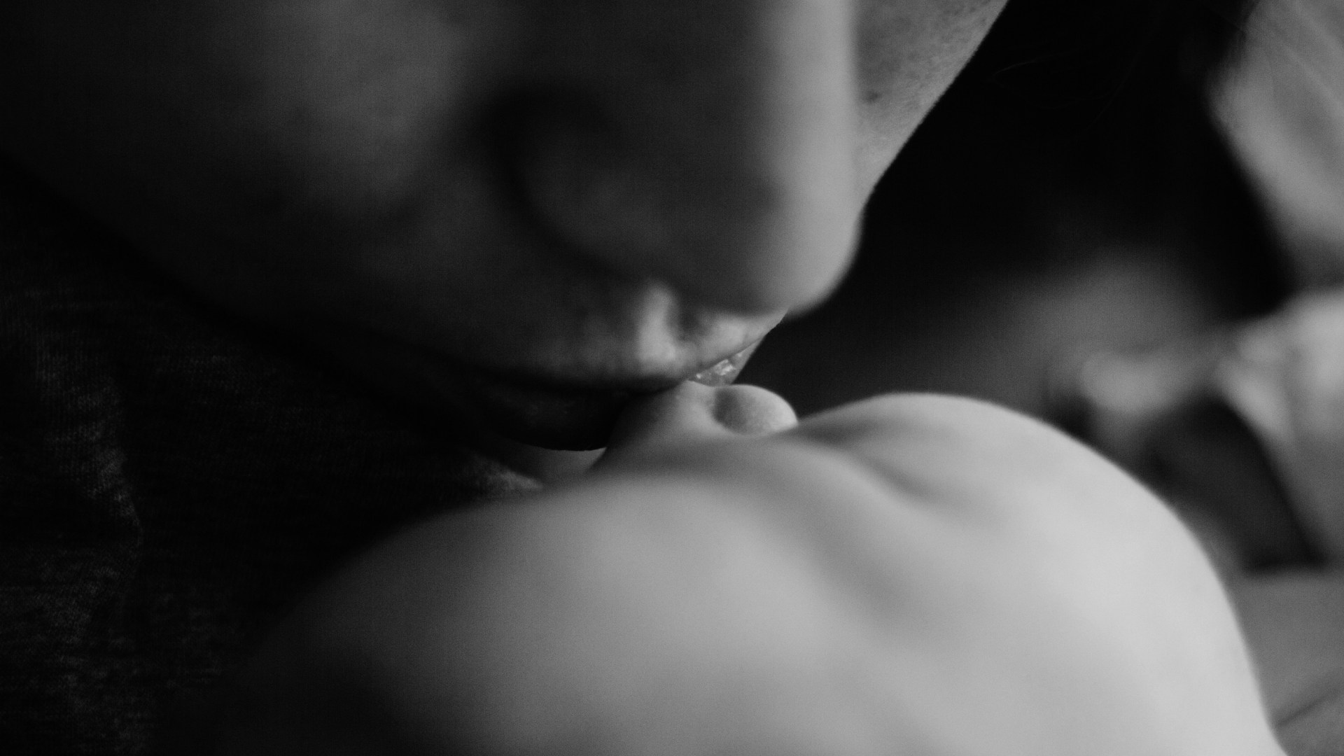 A mother kissing her baby.