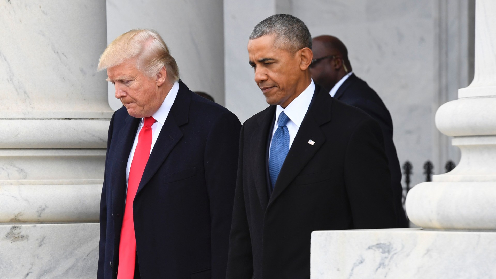 Trump and Obama walking at the White House.