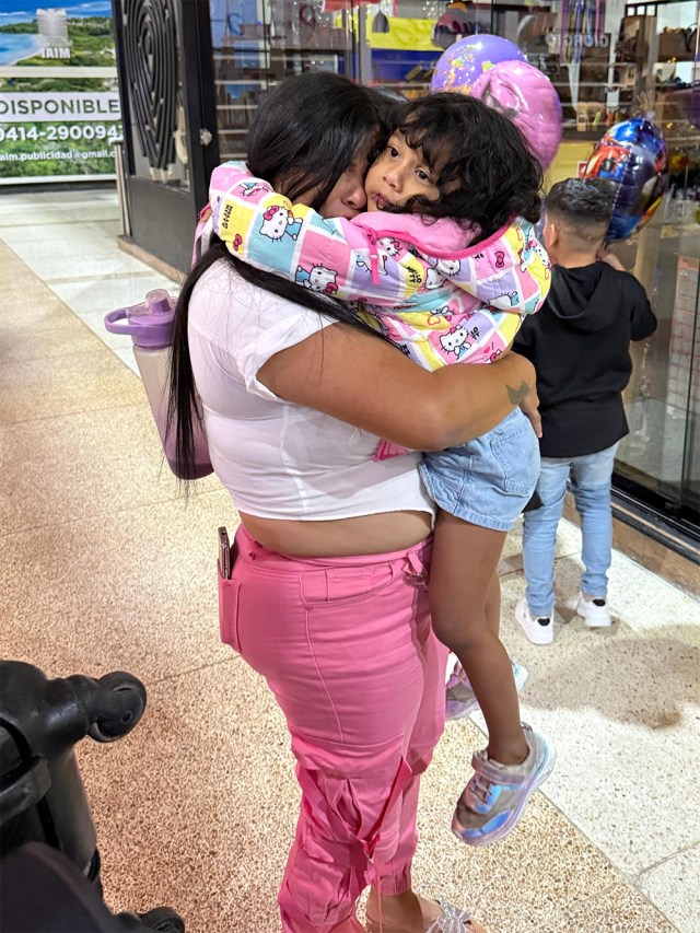 A mom hugging her child.