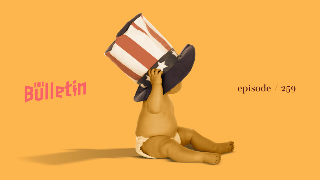 A baby wearing a tall American flag hat.