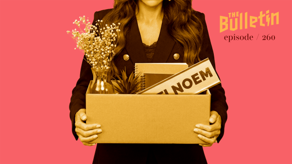 Kristi Noem holding a box with flowers and a sign with her name on it.
