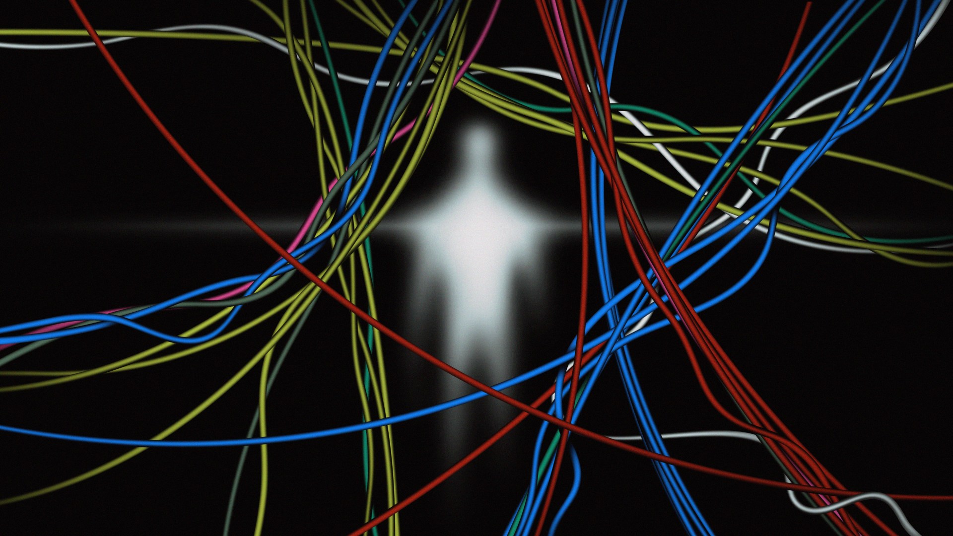 Blurred glowing human figure behind a tangle of colorful cables against a dark background.