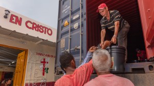 Members of the Iglesia Hermanos en Cristo Faro de Luz unloading supplies that will be distributed to people in the church and the community.