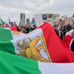 Protestors in Canada carry a large Iranian flag as part of a Global Day of Action protest against the Islamic Republic of Iran on February 14, 2026.