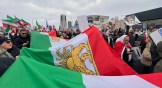 Protestors in Canada carry a large Iranian flag as part of a Global Day of Action protest against the Islamic Republic of Iran on February 14, 2026.
