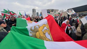 Protestors in Canada carry a large Iranian flag as part of a Global Day of Action protest against the Islamic Republic of Iran on February 14, 2026.