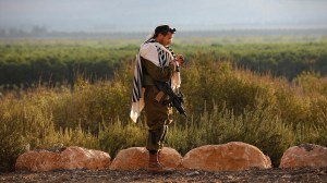 An Israeli soldier prays at a military position in the north of Israel near the border with Lebanon on October 15, 2023.