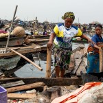 Residents evacuate in a boat following forceful eviction and demolition of homes in the Makoko slum in Nigeria.