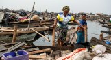 Residents evacuate in a boat following forceful eviction and demolition of homes in the Makoko slum in Nigeria.