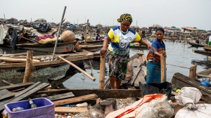 Residents evacuate in a boat following forceful eviction and demolition of homes in the Makoko slum in Nigeria.