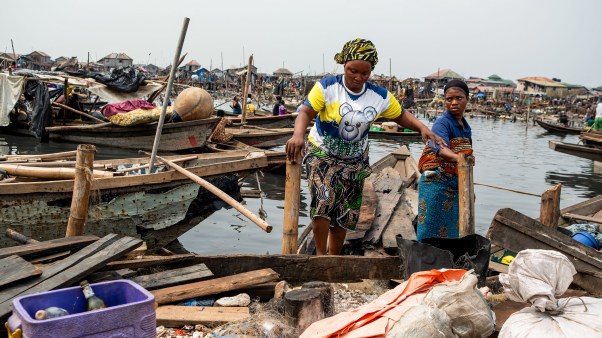 Residents evacuate in a boat following forceful eviction and demolition of homes in the Makoko slum in Nigeria.
