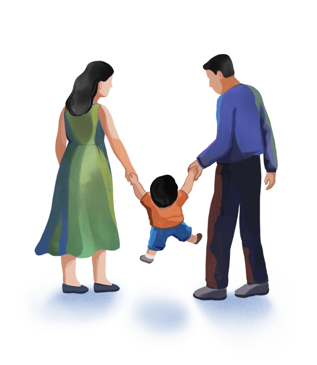 Parents holding their child’s hands and lifting the child while walking together.