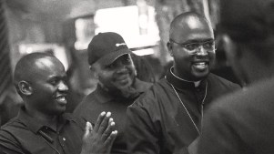 Padre Micheal Watenga preaching in a nightclub.