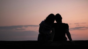 A couple sitting by the beach.