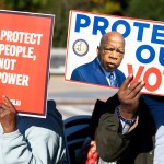Voting rights activists protest outside the U.S. Supreme Court as it prepares to hear a case challenging Louisiana's congressional map on Wednesday, October 15, 2025.