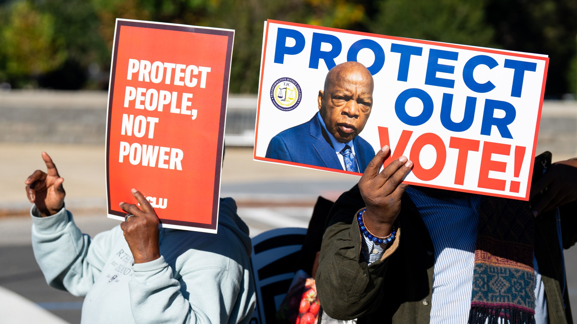 Voting rights activists protest outside the U.S. Supreme Court as it prepares to hear a case challenging Louisiana's congressional map on Wednesday, October 15, 2025.