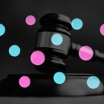 A gavel and pink and blue pills.