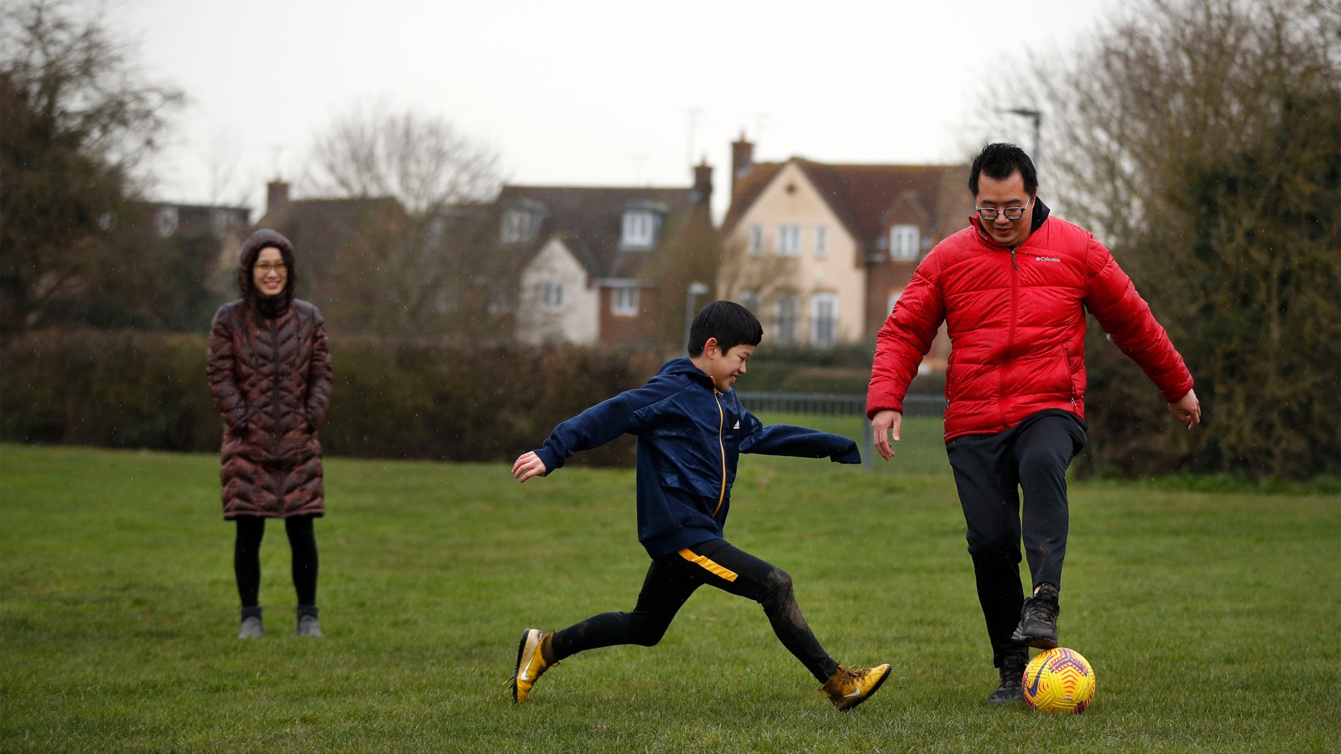 A family who arrived in Britain from Hong Kong plays football in Chelmsford on January 26, 2021.