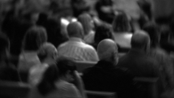 A blurred photo of a church congregation.
