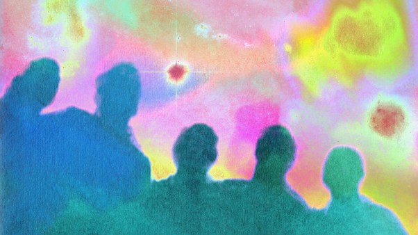 Silhouettes of people looking up at stars.