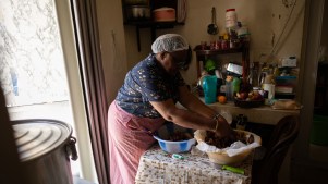 Mercy cooking meals to distribute with members of her organization, Women of Purpose.