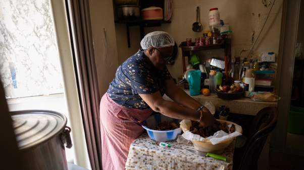 Mercy cooking meals to distribute with members of her organization, Women of Purpose.